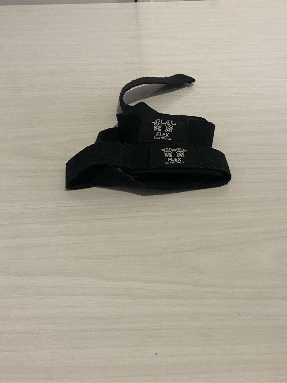 Black wrist wrap with a brand logo